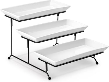 a three tiered tray of white dishes