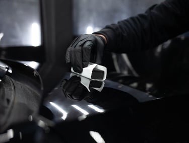 a person wearing gloves and gloves holding a piece of luggage