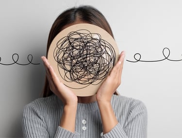 Woman holding a wooden circle with tangled scribbles symbolizing mental health, anxiety, and complex thoughts.
