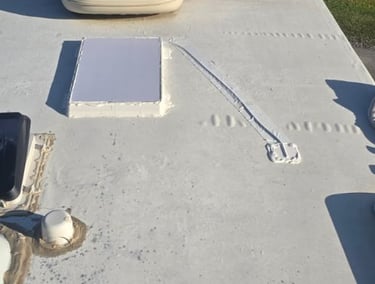 White rubber RV roof showing a custom mounted Starlink dish.