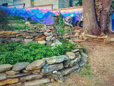 stone terraced backyard with painted wall in rear