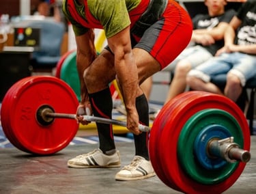 a man is doing a barbell deadlift in a gym