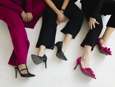 three women sitting on a bench with their feet up after wellness coaching with Megan Swan
