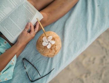une femme lis un livre sur la plage