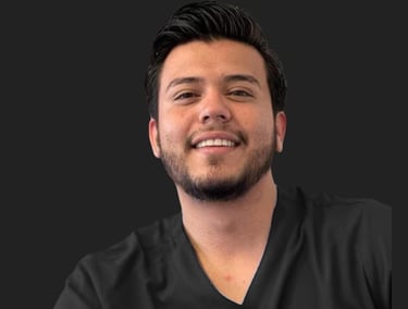 Smiling male healthcare professional in black medical scrubs against a dark background.