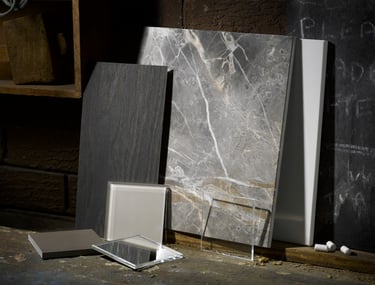 pieces of slate marble and glass leaning against the wall of an old workshop