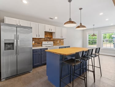 a kitchen with a wooden table and chairs