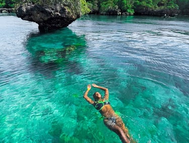 Tourist swimming in crystal-clear waters during Safari Blue Zanzibar boat tour, enjoying snorkeling and marine life adventure