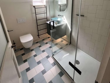 a bathroom with a shower and a toilet fitted by pbp services