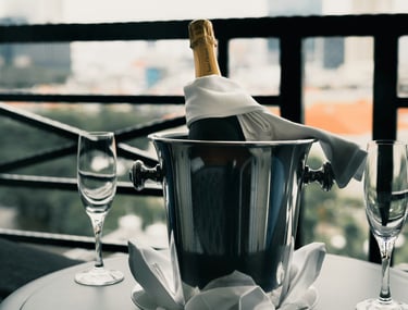 Chilled champagne bucket with two glasses; Photo by Albert Vincent Wu on Unsplash