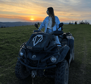a woman sitting on a quad - atv atv