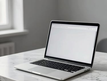 A sleek silver laptop open on a white marble desk. Screen displays a minimalist homepage design. Soft natural light, grey walls, very clean and modern Turkish interior.
