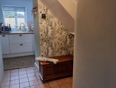 A finished wallpapering under the stairs in a residential home.
