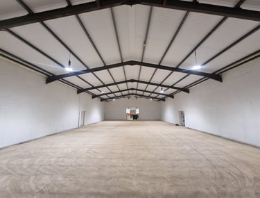 A large, open interior of a warehouse painted white.