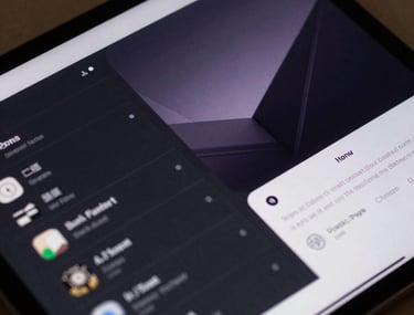 A close-up of a high-tech tablet showing a sleek dashboard interface with minimalist design elements and purple highlights.