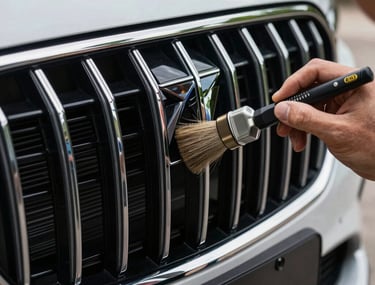 The front grill of a luxury car being hand-detailed with a fine brush, showcasing precision work in French / Charente-Maritime.