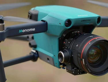 A close-up shot of a professional camera gimbal on a drone, reflecting the teal and navy brand colors. Clean, tech-focused studio lighting.