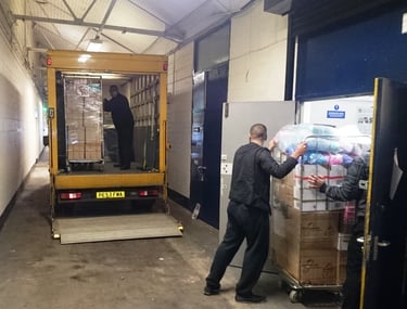 Man and Van hired by shopkeeper loading from their warehouse