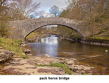 packhorse bridge spanning stainforth beck over still water