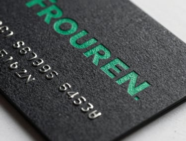 Clean macro shot of a sleek black business card with emerald green embossed typography, professional and reliable brand aesthetic.