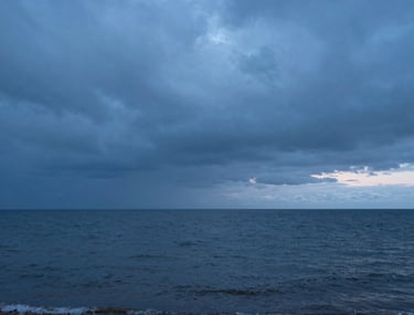 A peaceful Baltic coastline during the blue hour, representing the vastness of human emotion and the possibility of calm after a storm.