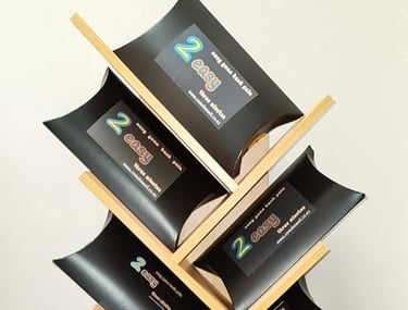 2 Easy’ back‑pain relief products arranged on a wooden display