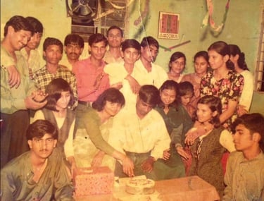 a group of people standing around a table