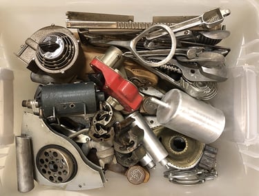 Metal parts in a sculptor's workshop bin, image 1.