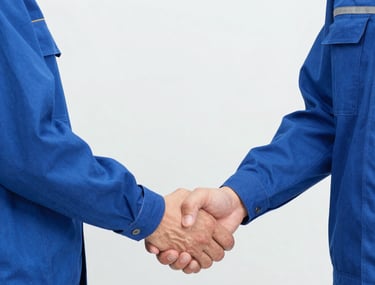 Family-owned excavating team working together on a country dirt lot with trees nearby.