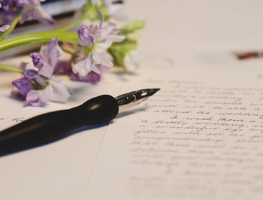 Fountain pen and flowers on a letter for mindful journaling.