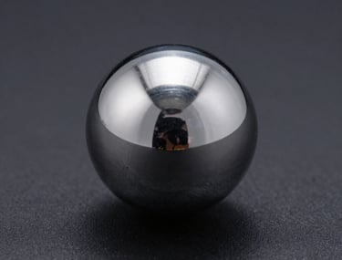 Macro shot of a silver chrome sphere on a matte black surface. Perfect reflections, sharp edges, and a sense of industrial engineering.