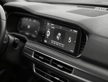 Editorial black and white shot of a modern car's dashboard, showing only the precise digital display and leather stitching. Seductive and restrained.