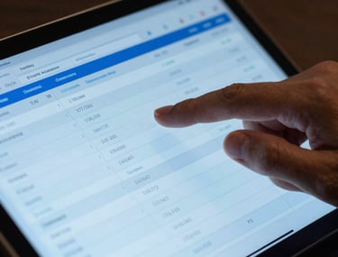 A close-up photograph of a South American professional's hand interacting with a high-tech tablet displaying a complex financial ledger. The lighting is crisp, using royal blue and sky blue tones to highlight the intersection of finance and technology. Professional and sharp aesthetic.