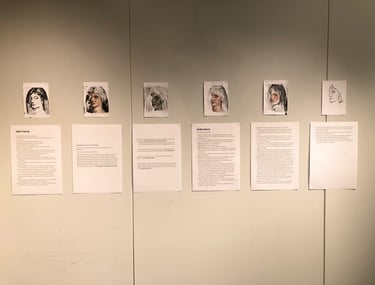 6 mixed media portraits of a lady on a gallery wall. Text is displayed under each portrait.