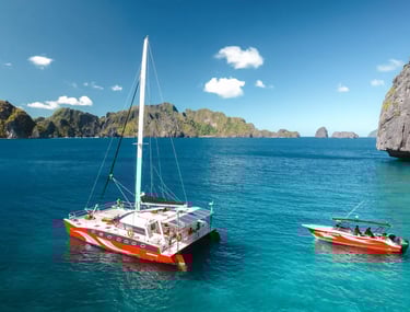 Private luxury yacht cruising through Bacuit Bay, El Nido.