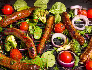 Sustainable plant-based, nutritionally-dense, hypoallergenic protein and fibre sausages with vegetables surrounding