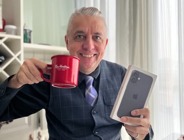 a man in a suit and tie holding a cup of coffee