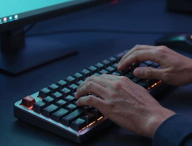 Close-up of a software engineer's hands typing on a modern mechanical keyboard, dark navy blue environment with soft teal monitor glow, highly professional and focused.