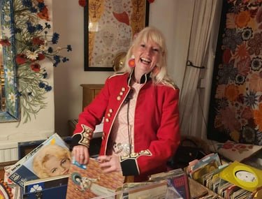 DJ Charlotte Hypno Bird playing records at a 60th birthday party wearing 60s vintage dress 