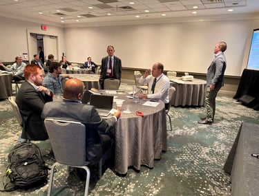 Nick Reese facilitating crisis simulation with several people in suits participating