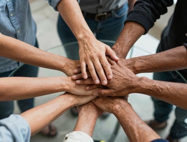 Multiple hands of diverse professionals stacked together over a glass table, representing collaboration and unity, South American context.