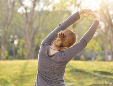 a woman stretching her arms in the air