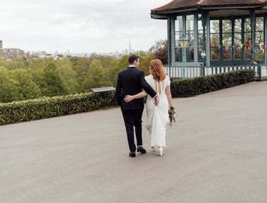 bride and groom holding each other and walking on the street with view