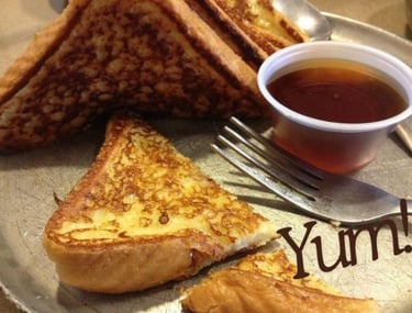 An image of French toast with maple syrup