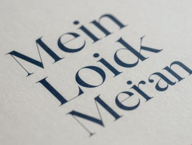 Clean, macro shot of a typography specimen sheet featuring elegant serif fonts. Lighting is soft and cinematic, deep blue and off-white tones, Latin American / Hispanic design studio.