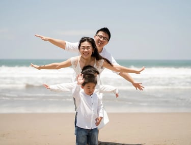 Playful family portrait during a beach family session at W Bali Seminyak