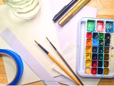 pictureup watercolour materials, colour palette, brushes, water jar, tape, paper, goldpen, fineliner