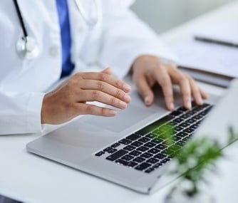 A doctor in front of her laptop