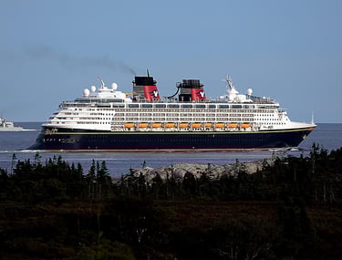 Disney Magic ocean cruise ship underway—Disney Cruise Line family cruises, coastal scenery
