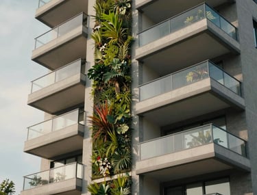 Exterior facade of a modern apartment building with vertical garden elements and large balconies. Soft daylight.
